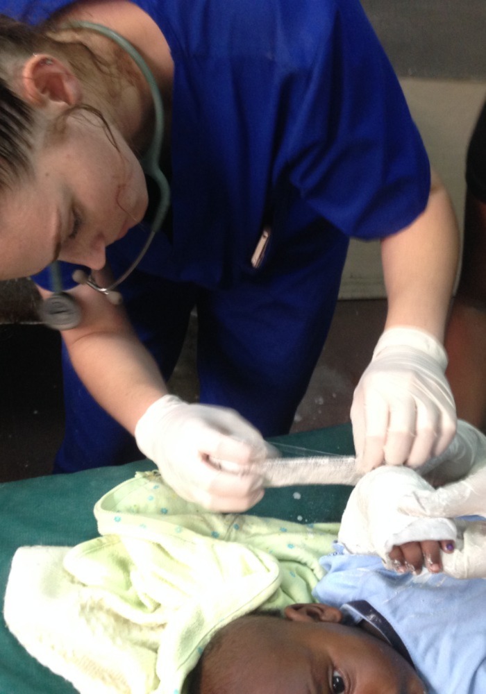 Medical volunteer student providing care to an infant